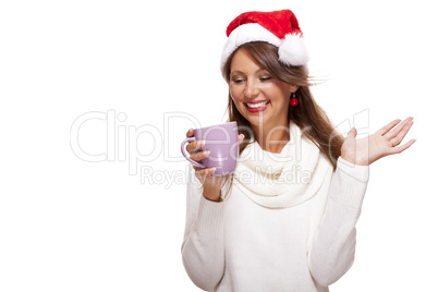 Cold young woman in a Santa hat sipping coffee tea