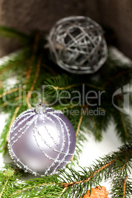 Silver Christmas ornaments in leaves