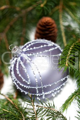 Silver Christmas ornaments in leaves