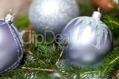 Silver Christmas ornaments in leaves