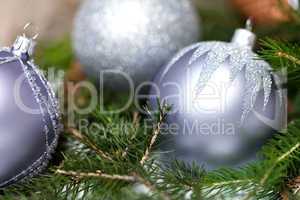 Silver Christmas ornaments in leaves