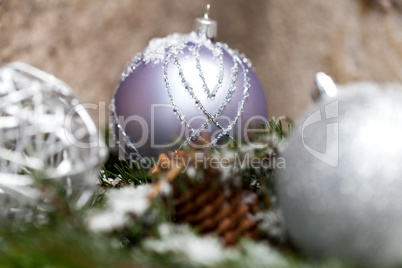 Silver Christmas bauble on a tree with snow