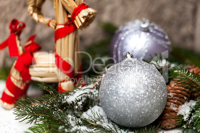 Silver Christmas bauble on a tree with snow