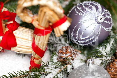 Silver Christmas bauble on a tree with snow