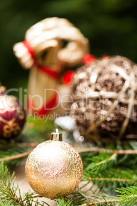 Gold Christmas ornament on leaves