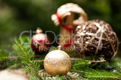 Gold Christmas ornament on leaves