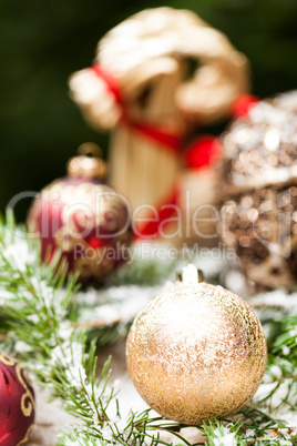 Gold Christmas ornament on leaves