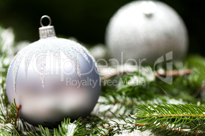 Silver Christmas ornaments in leaves