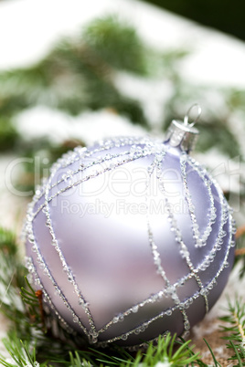 Silver Christmas ornaments in leaves