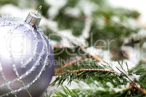 Silver Christmas ornaments in leaves