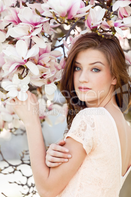 beautiful young woman and pink magnolia