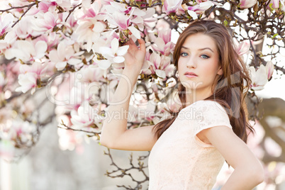 beautiful young woman and pink magnolia