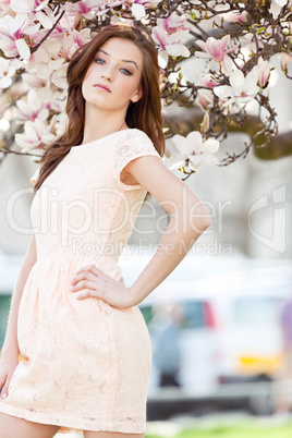 beautiful young woman and pink magnolia