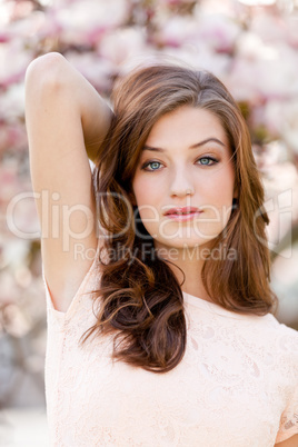 beautiful young woman and pink magnolia