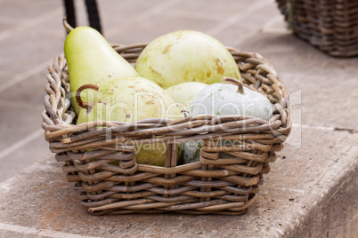 Fresh ripe pears in a wicker basket