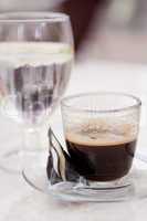 hot aromatic espresso cup and cold water in glass