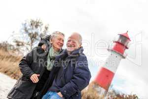 happy mature couple relaxing baltic sea dunes