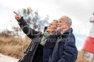 happy mature couple relaxing baltic sea dunes