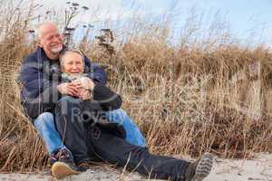 happy mature couple relaxing baltic sea dunes