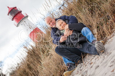 happy mature couple relaxing baltic sea dunes