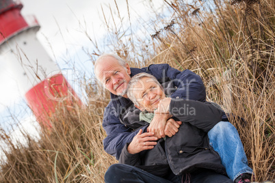 happy mature couple relaxing baltic sea dunes