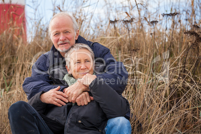 happy mature couple relaxing baltic sea dunes