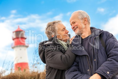 happy mature couple relaxing baltic sea dunes