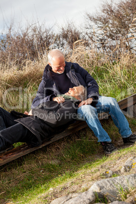 happy senior couple relaxing together in the sunshine