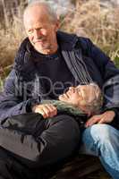 happy senior couple relaxing together in the sunshine