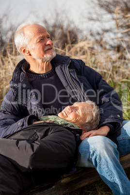 happy senior couple relaxing together in the sunshine