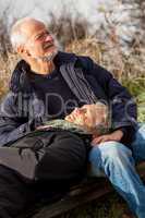 happy senior couple relaxing together in the sunshine