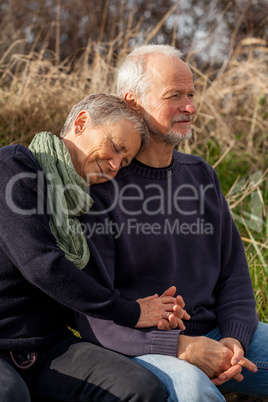 happy senior couple relaxing together in the sunshine