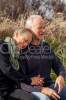 happy senior couple relaxing together in the sunshine