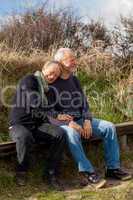 happy senior couple relaxing together in the sunshine