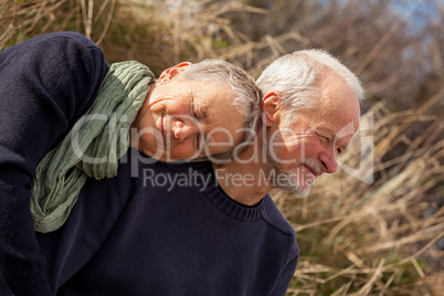 happy senior couple relaxing together in the sunshine