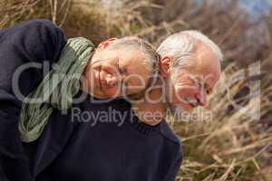 happy senior couple relaxing together in the sunshine