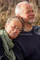 happy senior couple relaxing together in the sunshine