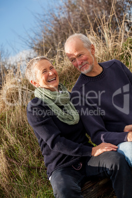 happy senior couple relaxing together in the sunshine