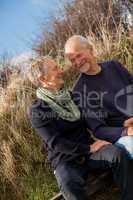 happy senior couple relaxing together in the sunshine