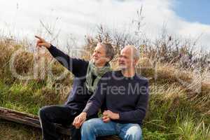 happy senior couple relaxing together in the sunshine