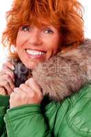 adult redhead woman with winter jacket smiling isolated