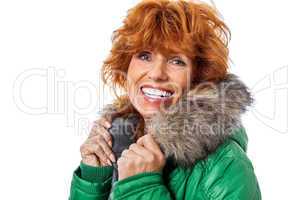 redhead smiling adult mature woman with geen warm jacket