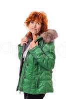 redhead smiling adult mature woman with geen warm jacket