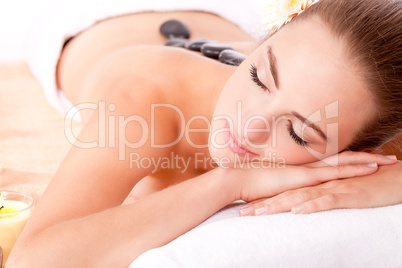 young attractive woman hot stone massage wellness isolated