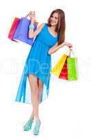 attractive young woman with colorful shopping bags isolated