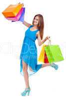 attractive young woman with colorful shopping bags isolated