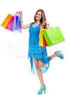 attractive young woman with colorful shopping bags isolated