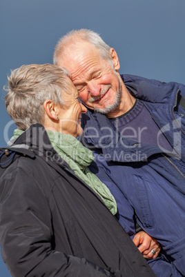 happy elderly senior couple walking on beach