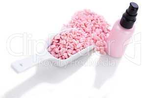 pink body lotion in dispenser and aroma salt isolated