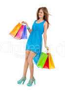 attractive young woman with colorful shopping bags isolated